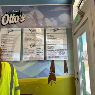 a woman standing in front of a menu