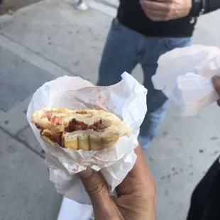 a person holding a hot dog