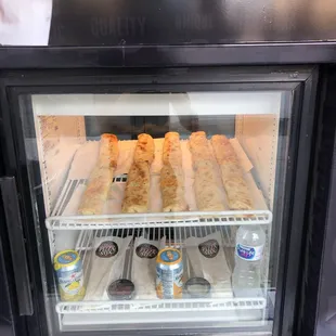 a man holding a can of pizza