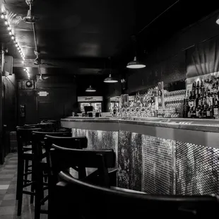 a black and white photo of the bar