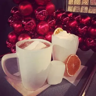 a cup of hot chocolate and orange slices