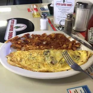 Swiss cheese and bacon omelette with well done hash browns and biscuits and gravy and water.