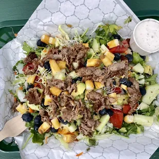 a salad with meat and fruit