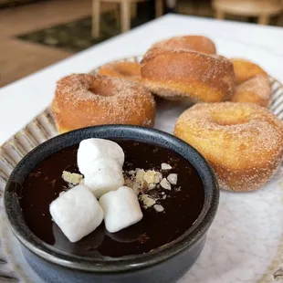 a plate of doughnuts and dipping sauce