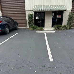 a parking lot with a car parked in front of it