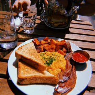 a plate of breakfast food on a wooden table