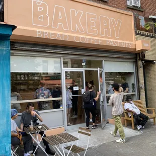 people sitting outside of a bakery