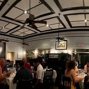 people sitting at tables in a restaurant