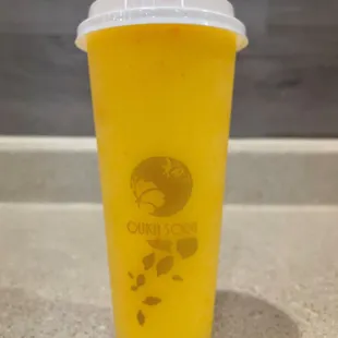 a yellow drink with a red apple on top