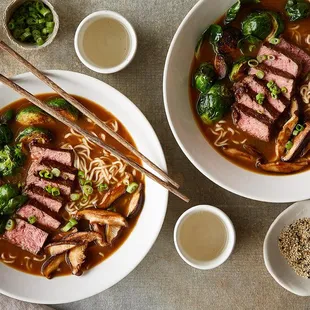 two bowls of beef and noodles