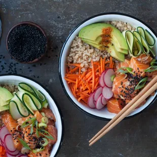 two bowls of food with chopsticks