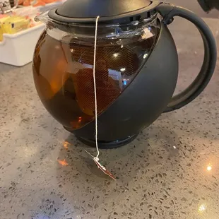 a teapot with a tea bag in it