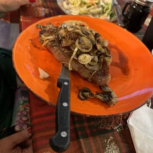 Porterhouse, steak, mushrooms, and onions, side salad
