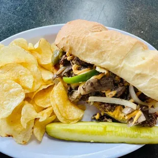 a pulled pork sandwich with pickles and chips