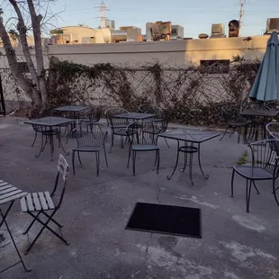 a patio area with tables and chairs