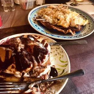 Chocolate chip pancakes with hashbrowns, scrambled eggs, and bacon