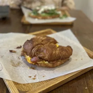 a croissant sandwich on a cutting board