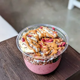 a smoothie in a plastic cup on a wooden table