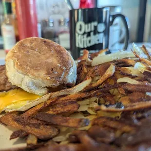 Egg, cheese, and sausage sandwich (English muffin) with hashbrowns (of course.)