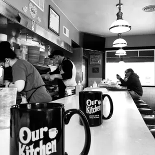 a black and white photo of a kitchen