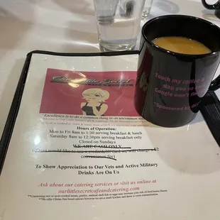 a cup of coffee and a menu