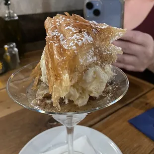 Deconstructed baklava with vanilla ice cream in a martini glass
