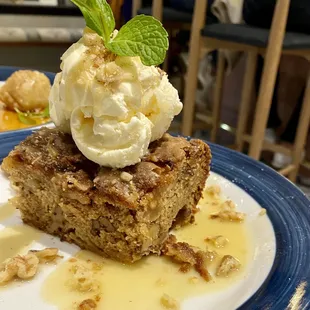 a piece of cake with ice cream and nuts