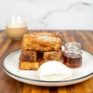 "Our French toast:" Cinnamon breaded dipped in an egg cream wash, with butter, powdered sugar, sweet condensed milk and real maple syrup.