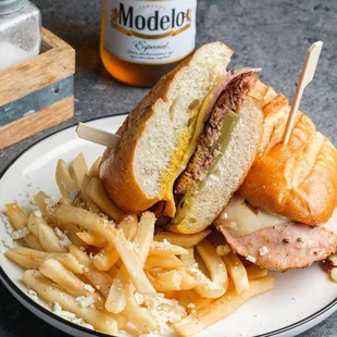 Our Cubano Sandwich: French style roll toasted with butter, with garlic aioli, pickles, mustard, sliced slow roasted pork, ham, and swiss.