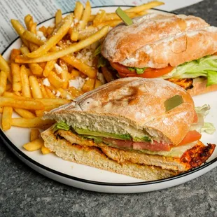 Blackened Chicken Sandwich: Organic chicken breast w/our signature blackened seasoning, Telera roll, lettuce, tomato, avocado, garlic aioli.