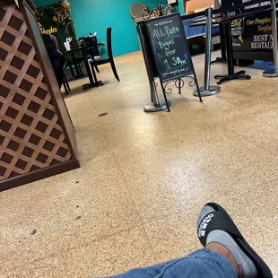 a person&apos;s feet in a restaurant
