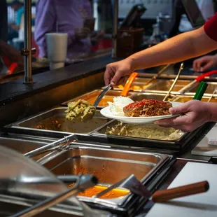 a person serving food to others