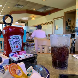 a ketchup bottle and a plate of food