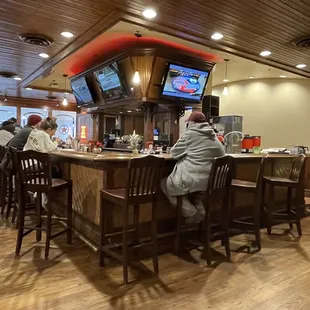 a group of people sitting at a bar