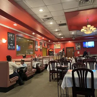 people sitting at tables in a restaurant