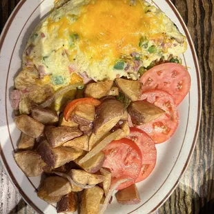 an omelet, potatoes and tomatoes