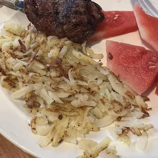 a steak, watermelon, onions, and watermelon