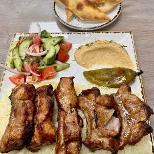 Pork Ribs, rice, salad, hummus and bread.
