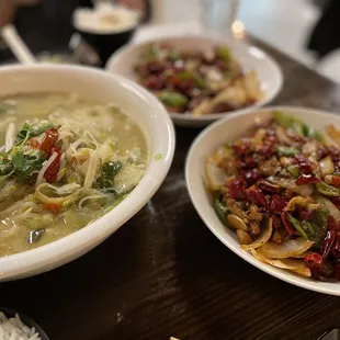 two bowls of soup and rice on a table