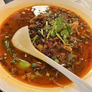 a bowl of soup with a spoon in it