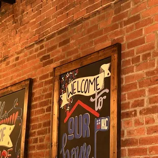 a sign on a brick wall