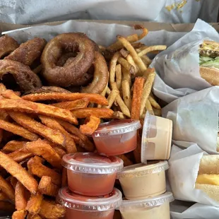 Double cheeseburger, bacon cheeseburger, grilled cheese with a side of fries, sweet potato fries and onion rings