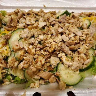 a salad in a styrofoam container