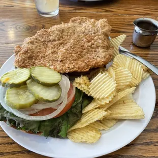 Pork tenderloin sandwich with potato chips. HUGE and delicious