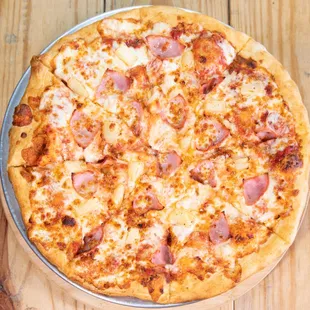 a pizza with ham and cheese