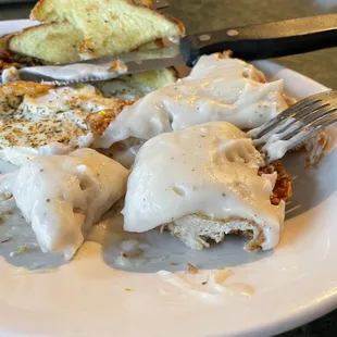 Chicken fried steak with peppered eggs, toast, and hashbrowns