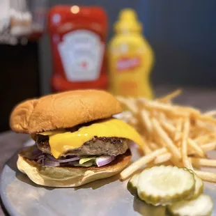 Burger w/ american cheese, lettuce, onions, lawry&apos;s mayo, potato bun | $14 + $4 fries