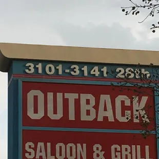 a sign for outback saloon and grill