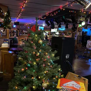 a decorated christmas tree in a bar