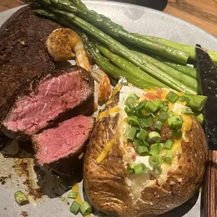 Rare sirlon, loaded potato, and asparagus
